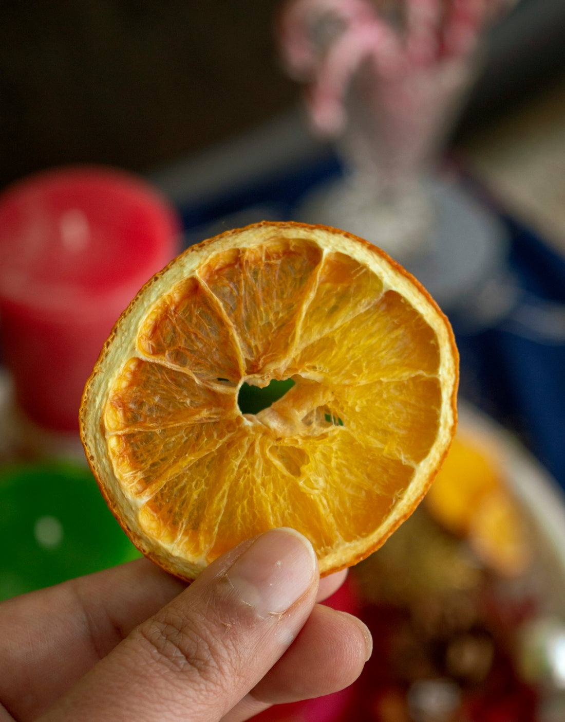 selective focus photography of person holding sliced and dried fruit