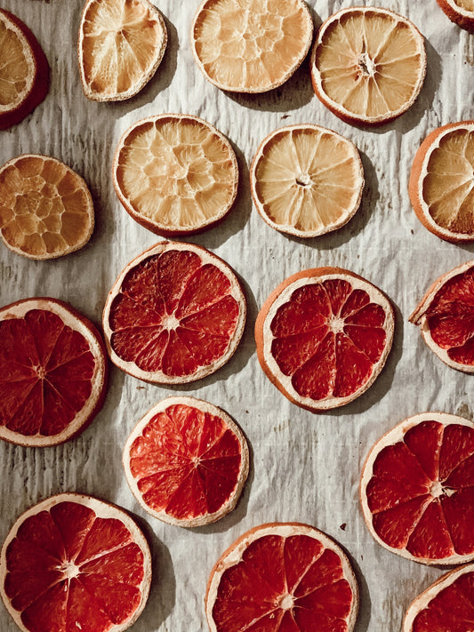 sliced orange fruit on white and blue textile