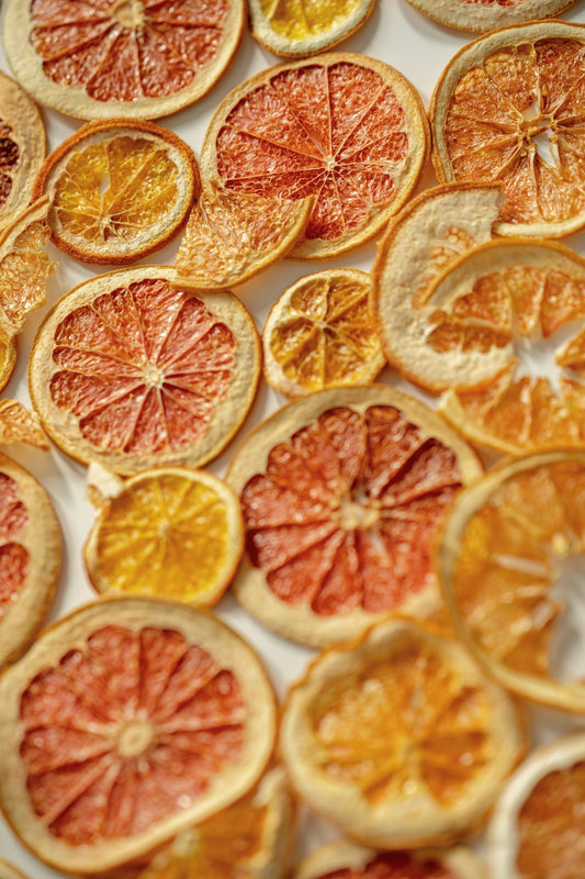 a bunch of oranges cut in half on a table