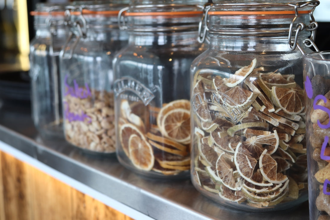 Dried citrus slices fill glass jars.